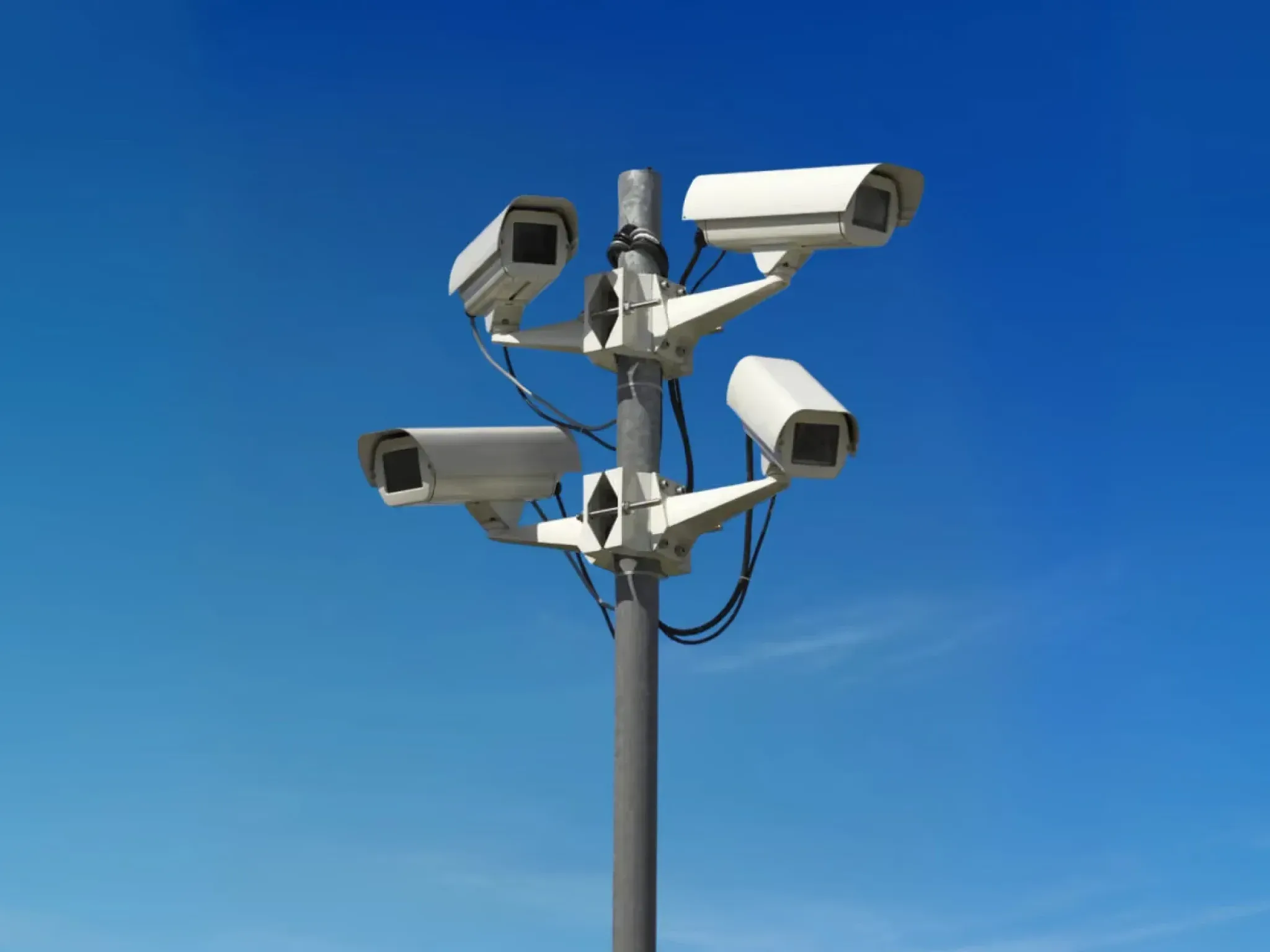 Security cameras on a pole against a blue sky