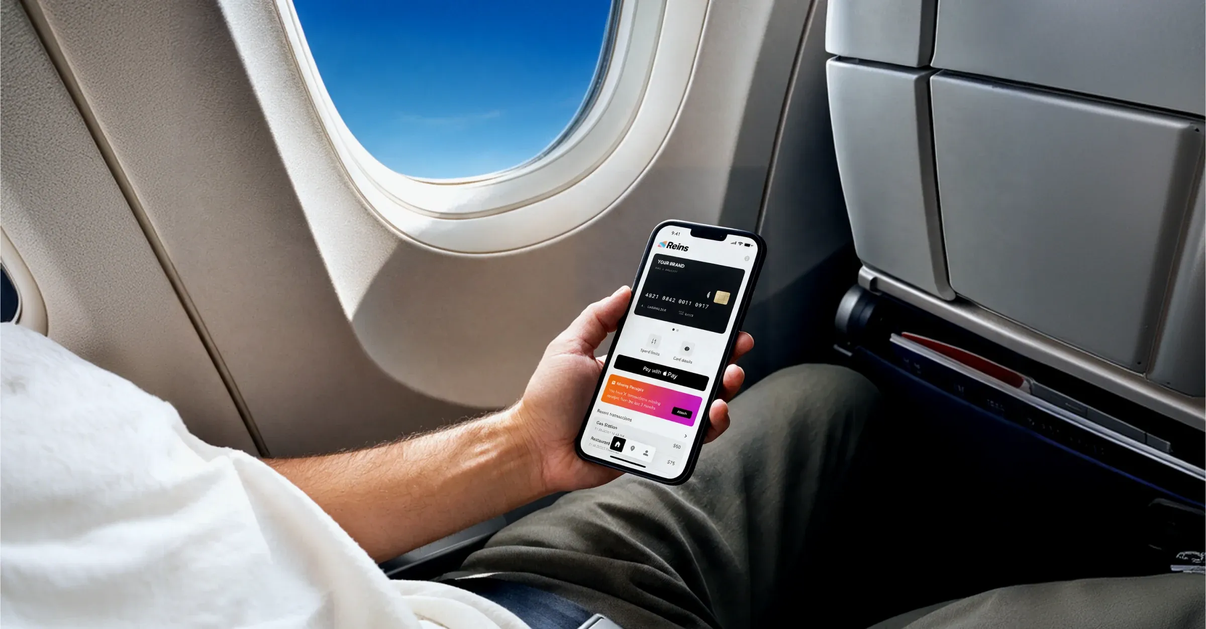 A man checking a payment app on his phone on a plane